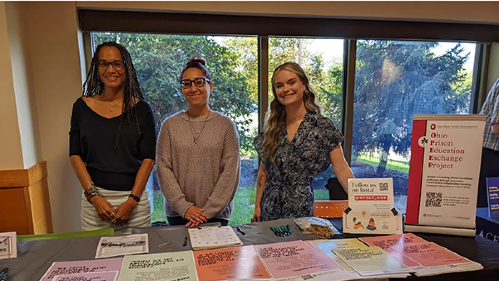 Dr. Tiyi Morris and OPEEP Program Coordinators Babette Cieskowski and Nicole Edgerton smile while tabling at the Newark campus student fair.