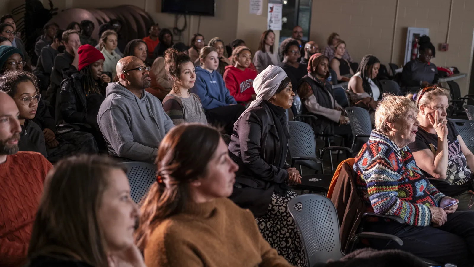 Members of the audience look onward during OPEEP's BackWall performance event on 1/31/2024.